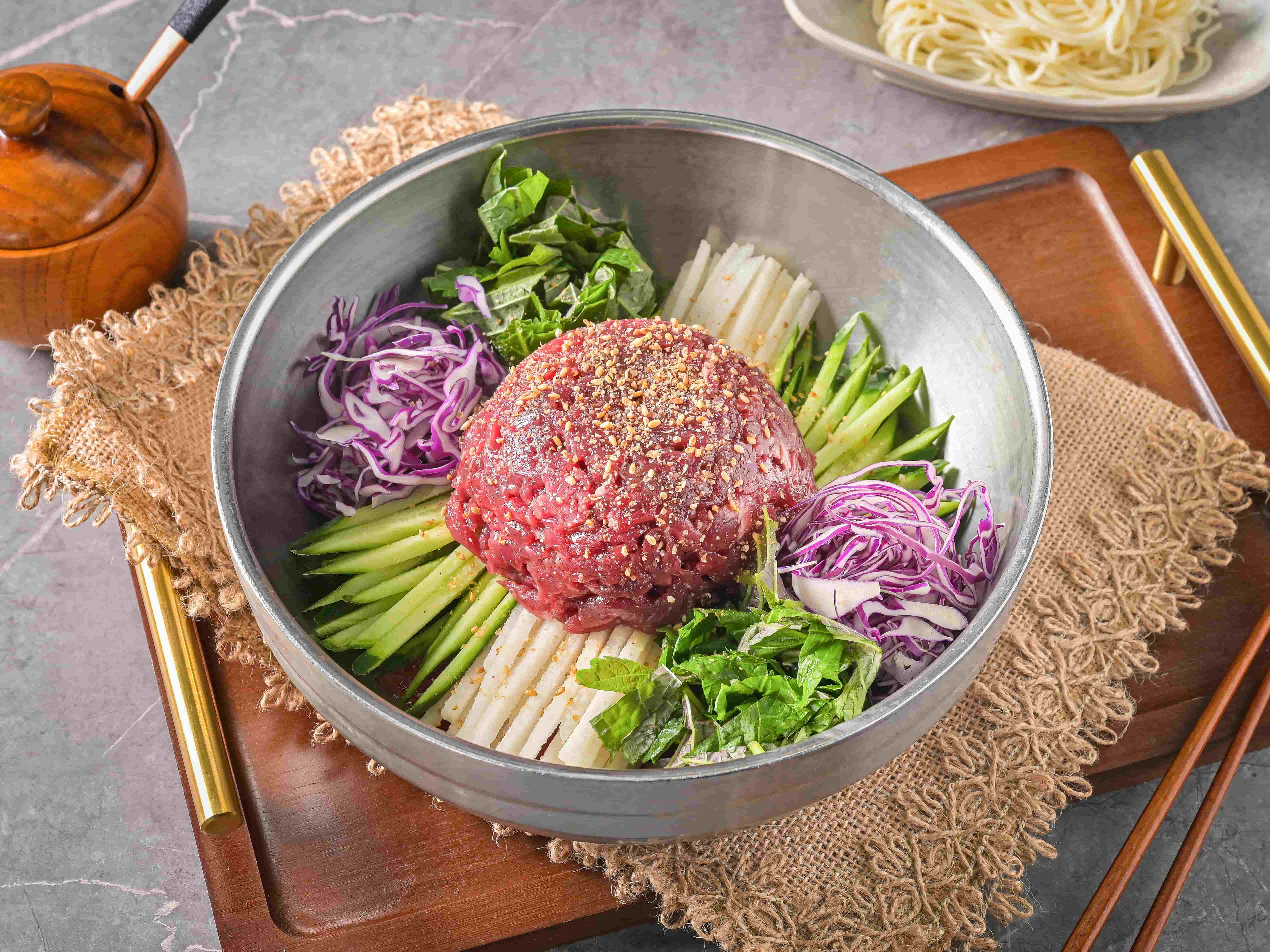 Raw beef in chilled broth